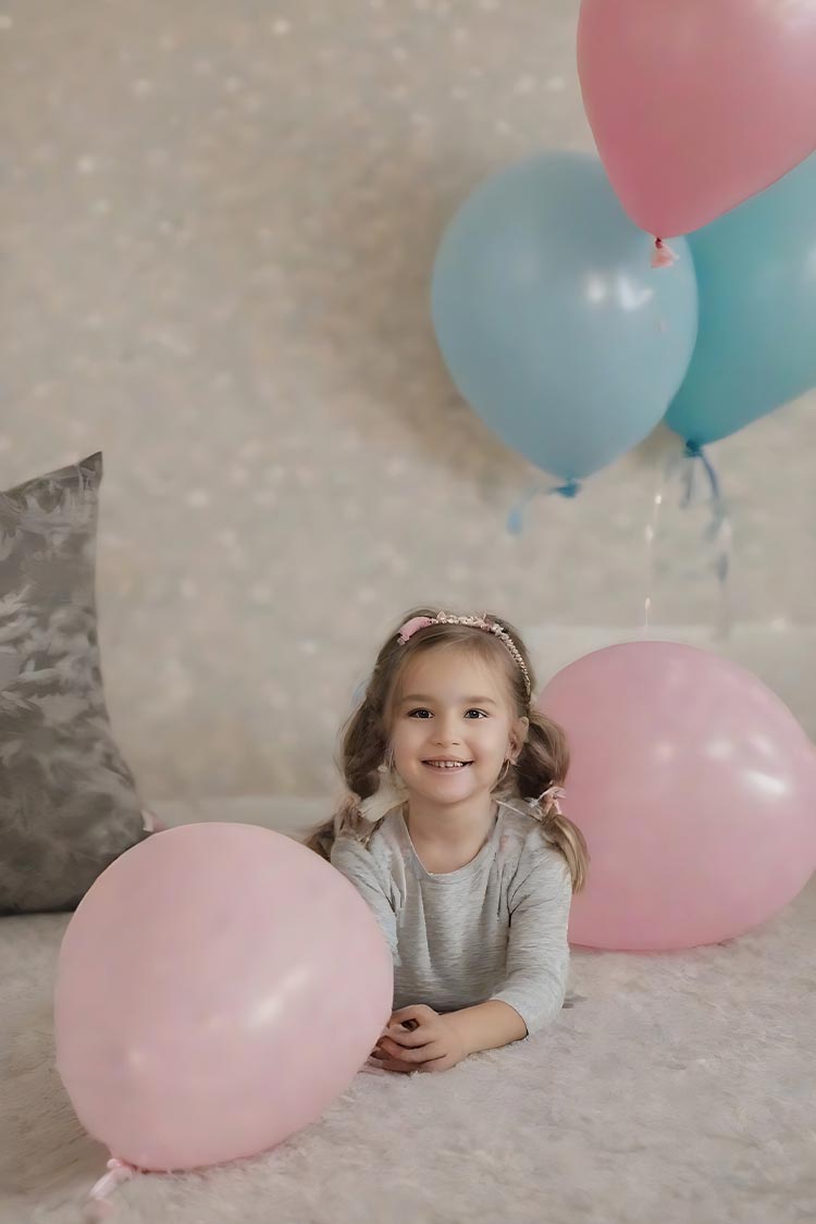 girl in carpet with pillow balloons